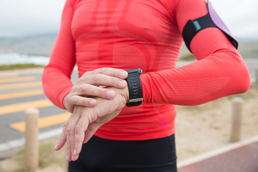 Person prüft beim Training die Herzfrequenz auf ihrer Smartwatch